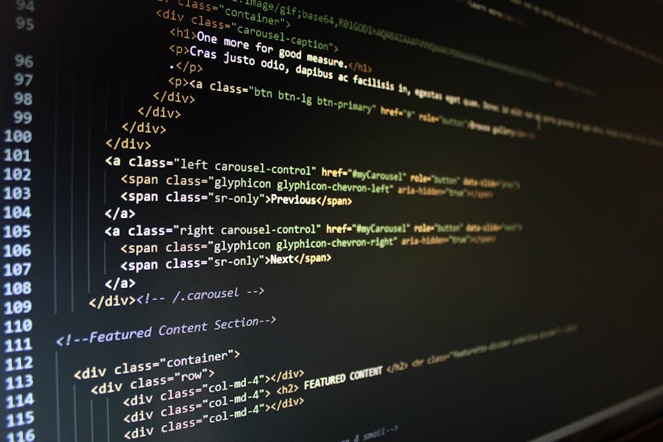 Close-up image of a computer screen displaying HTML code with highlighted tags and text, including aspects of website development. The screen shows lines of code with components such as 'div', 'span',
