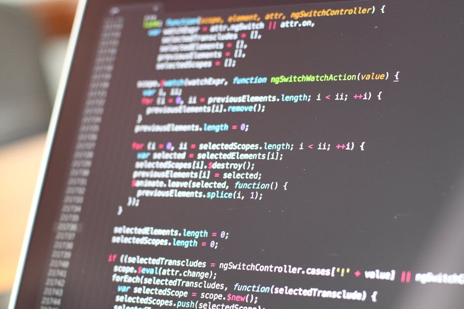 Close-up image of a computer screen displaying HTML code with highlighted tags and text, including aspects of website development. The screen shows lines of code with components such as 'div', 'span',